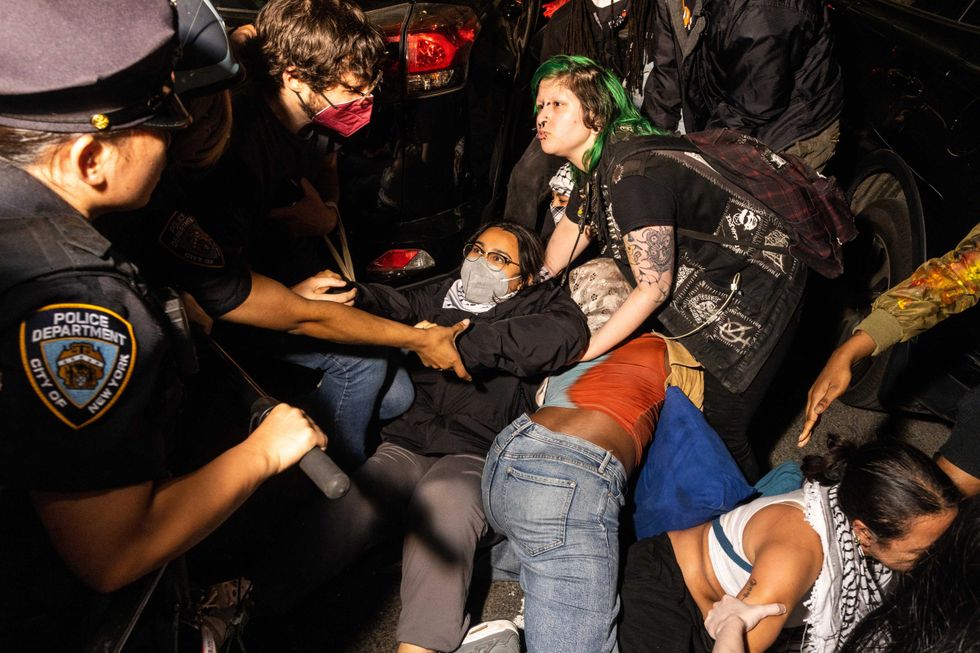 Police arrest demonstrators who were blocking the street after the clearing of a pro-Palestine encampment at the Fashion Institute of Technology on May 7, 2024