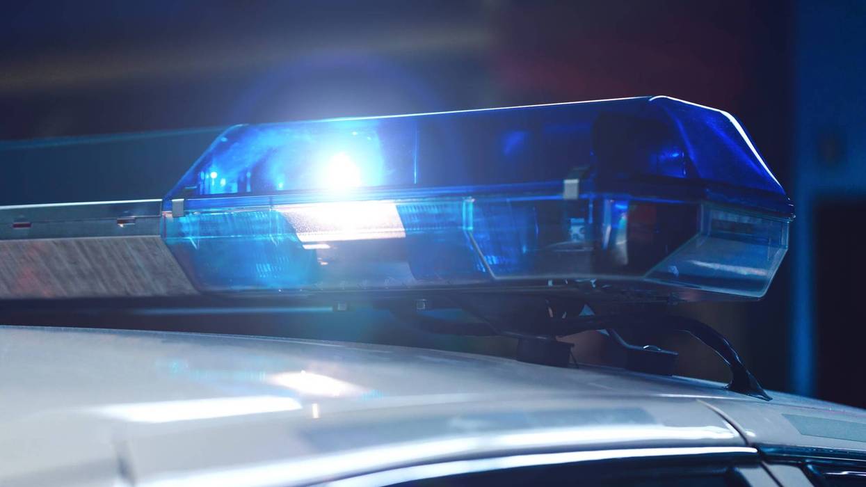 Police at night in the car with blue siren flasher.