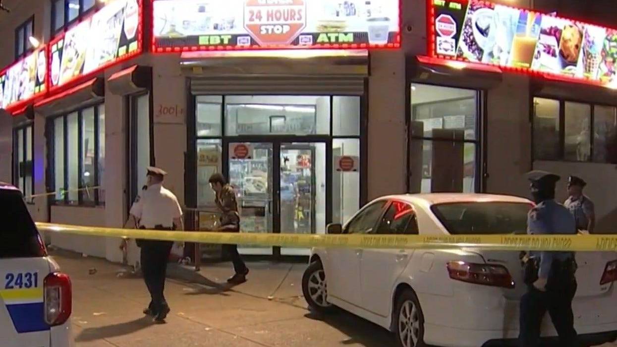 Police at the scene of an early Saturday shootout at a Kensington Quick Stop store.