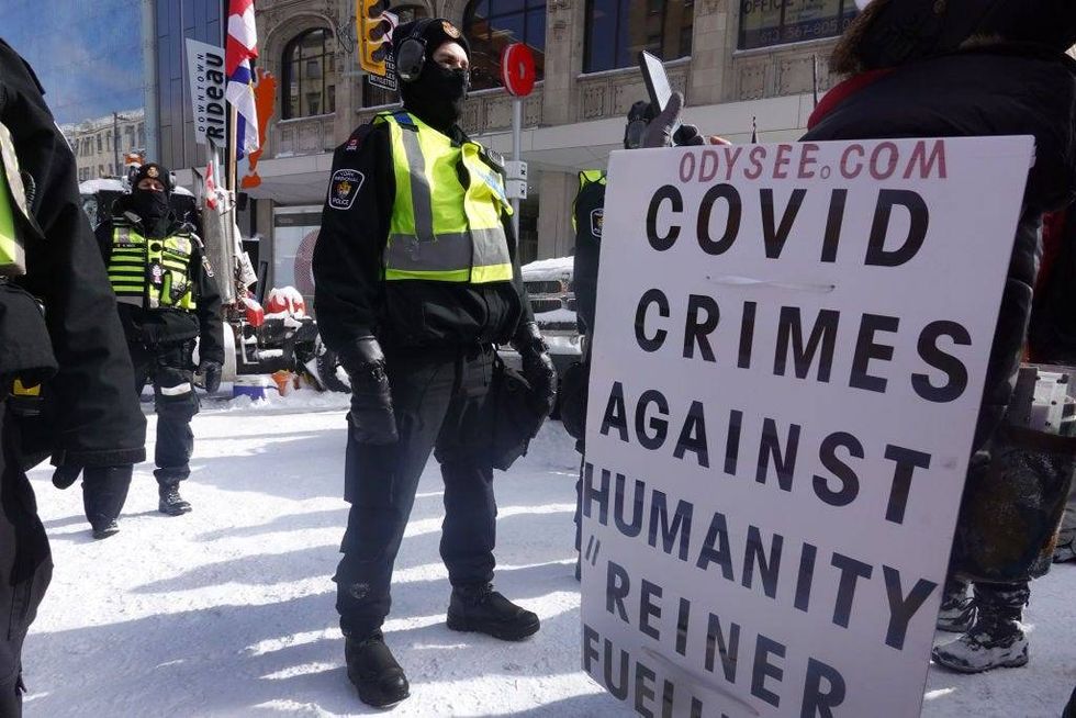 Police begin to break up a protest organized by truck drivers opposing vaccine mandates on February 18, 2022 in Ottawa, Ontario, Canada The drivers have used vehicles to form a blockade that has blocked several streets near Parliament Hill.
