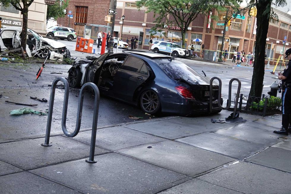 Police believe the driver of this black Mercedes ran a red light and crashed into the Honda before fleeing the scene on foot