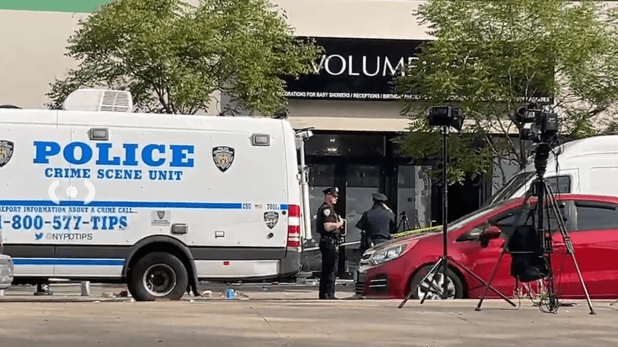 Police captured investigating the scene of an overnight shooting in Richmond Hill, Queens, on Saturday morning.