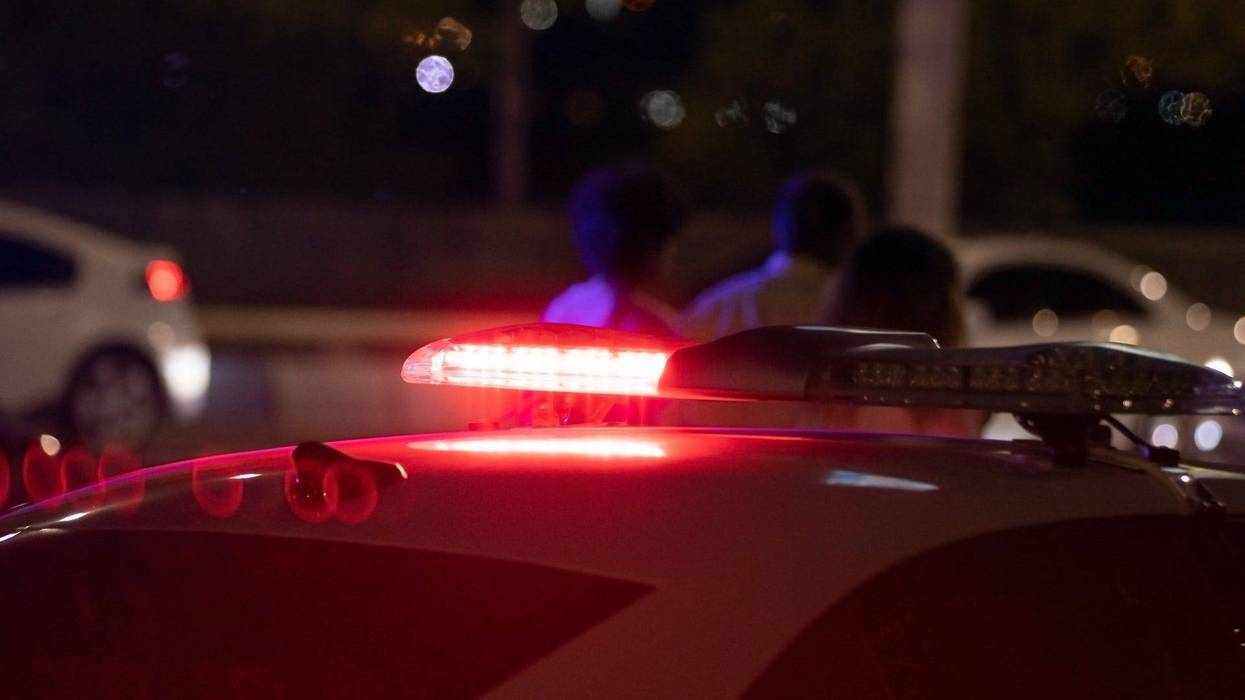 Police car at night time in the city - stock photo