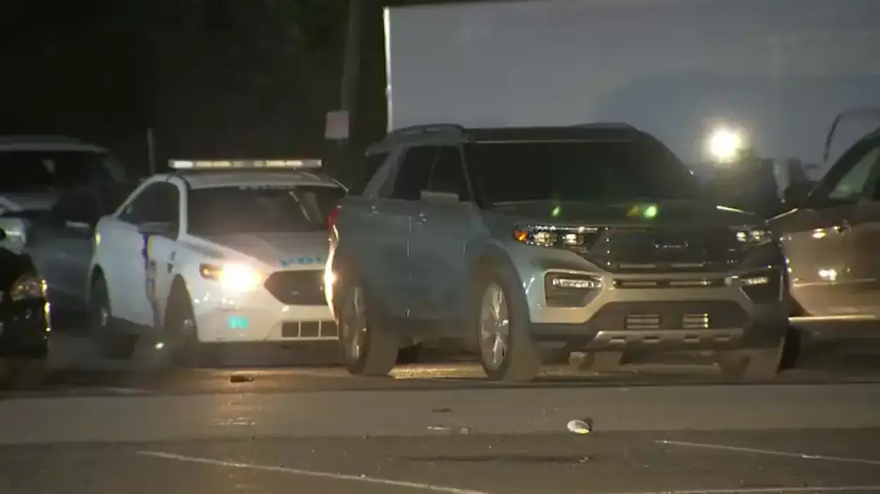 police car behind Ford Explorer in parking lot