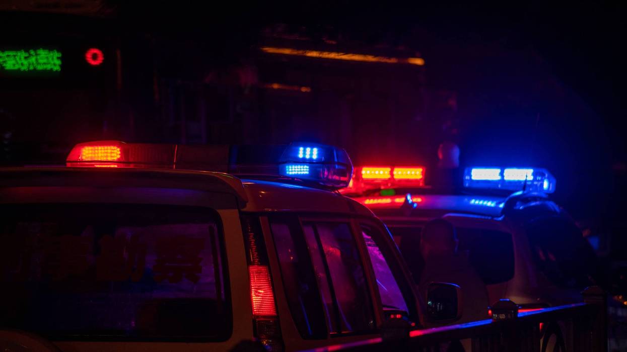 Police car lights at night in city with selective focus and bokeh.