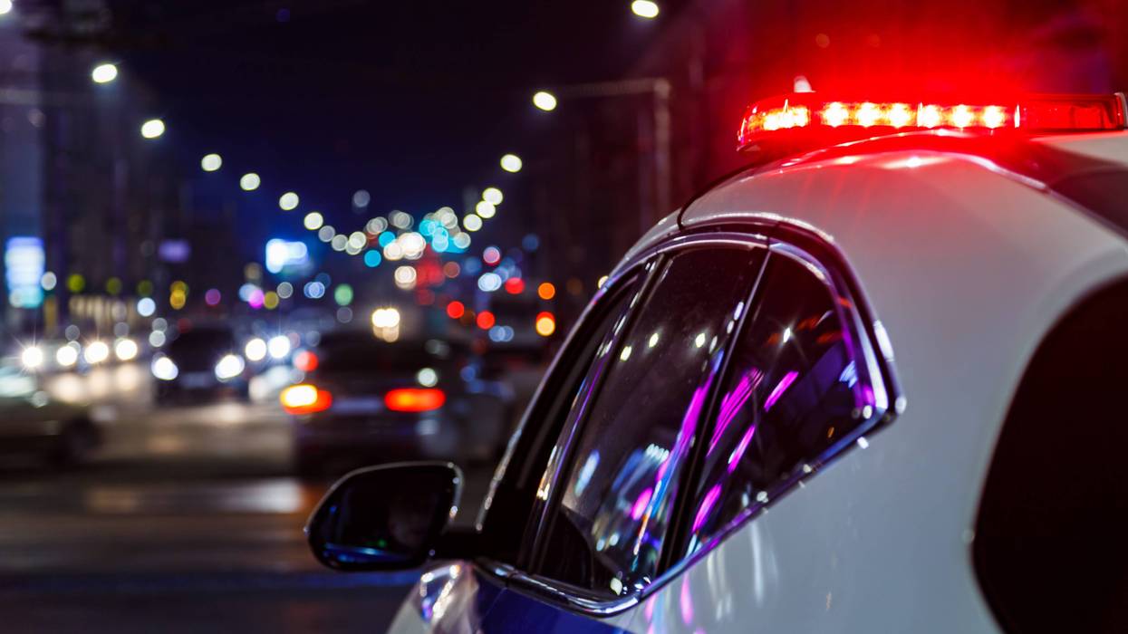 police car lights in night city with selective focus and bokeh - stock photo