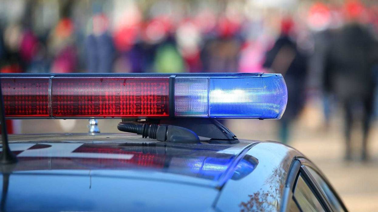 Police cars with sirens lit during the uprising through the streets of the city