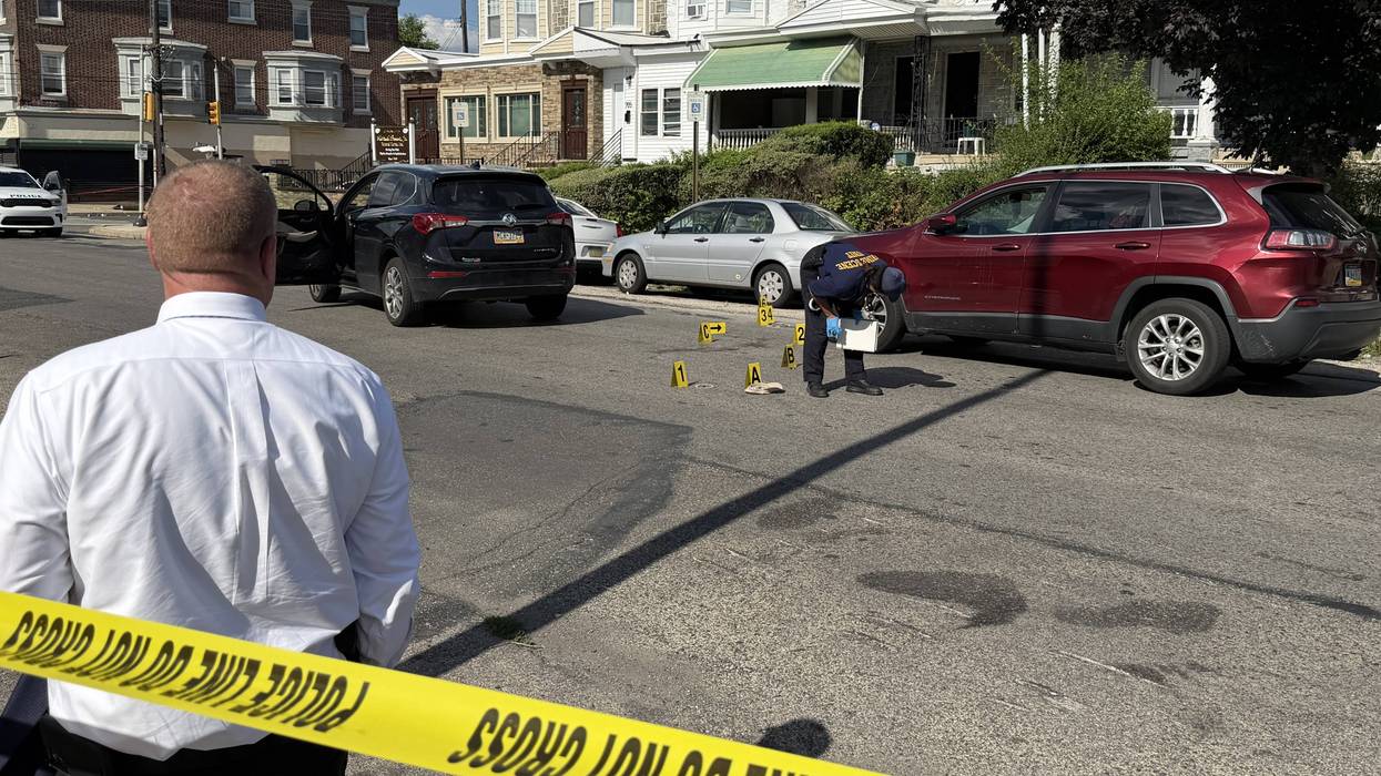 Police collect evidence at the scene of a fight-turned-deadly shooting in West Philadelphia on Wednesday, July 8.