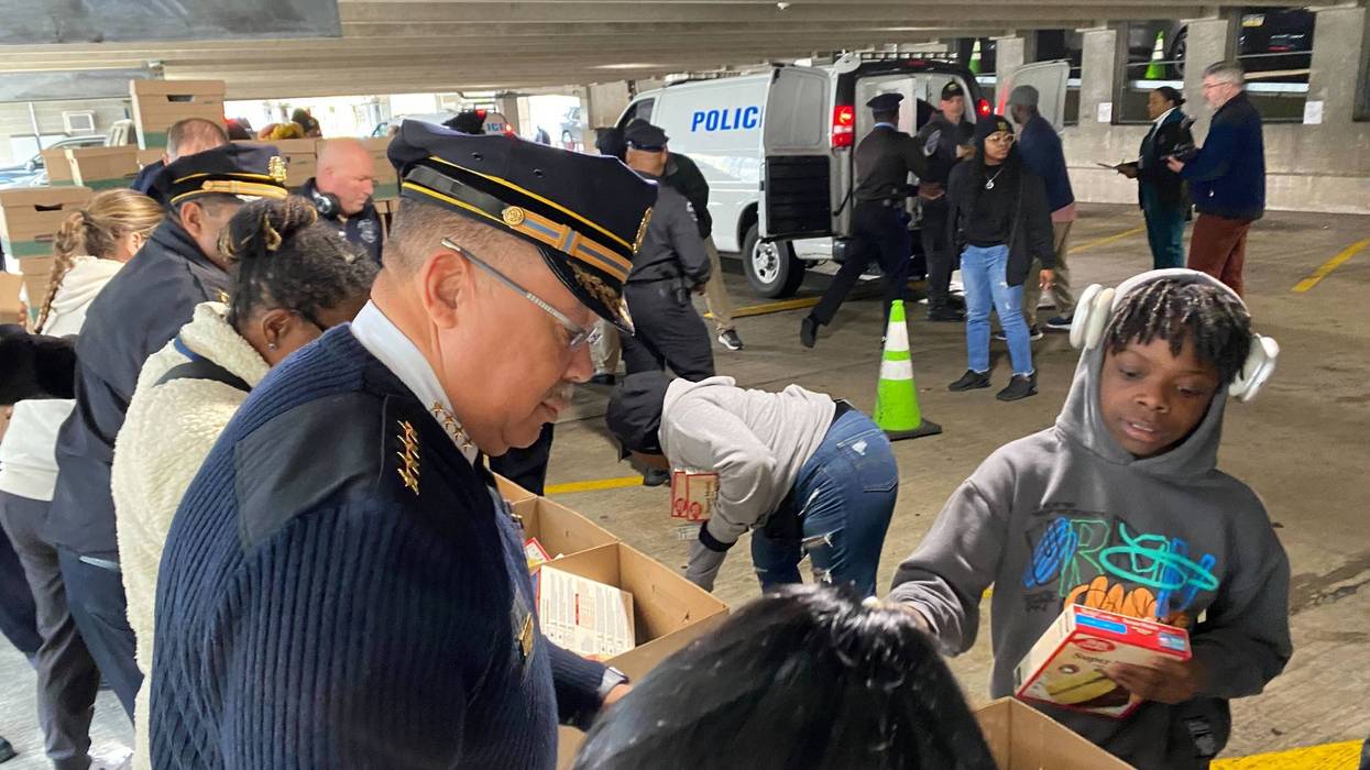 Police Commissioner Kevin Bethel helps pack dinner boxes for families in need as part of the 58th annual Operation Thanksgiving, Nov. 26, 2024.