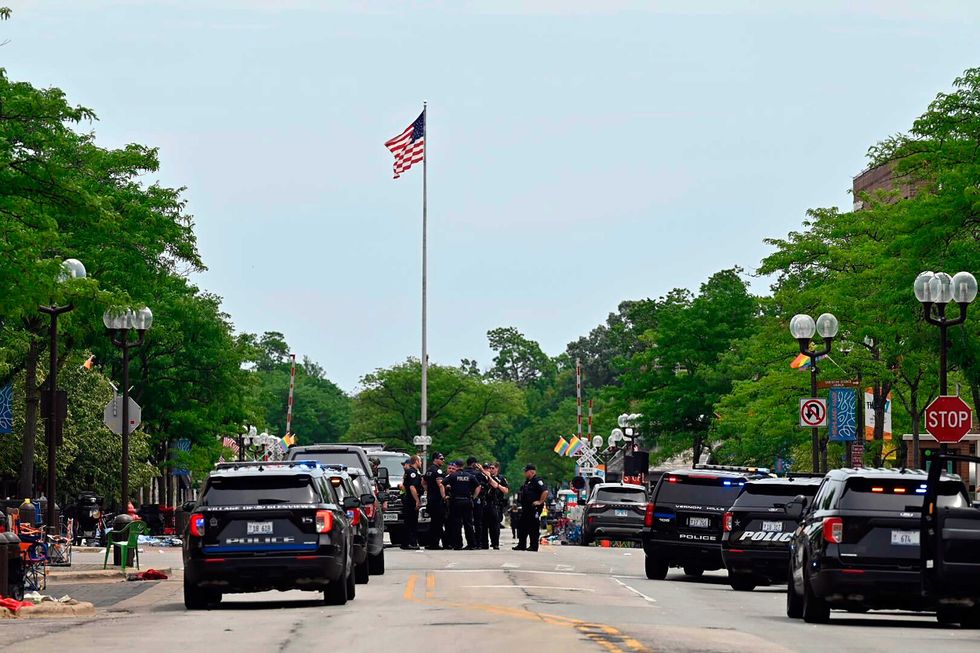 Police from several local municipalities including the Illinois State Police search downtown Highland Park after the mass shooting at the Fourth of July parade on Monday, July 4, 2022