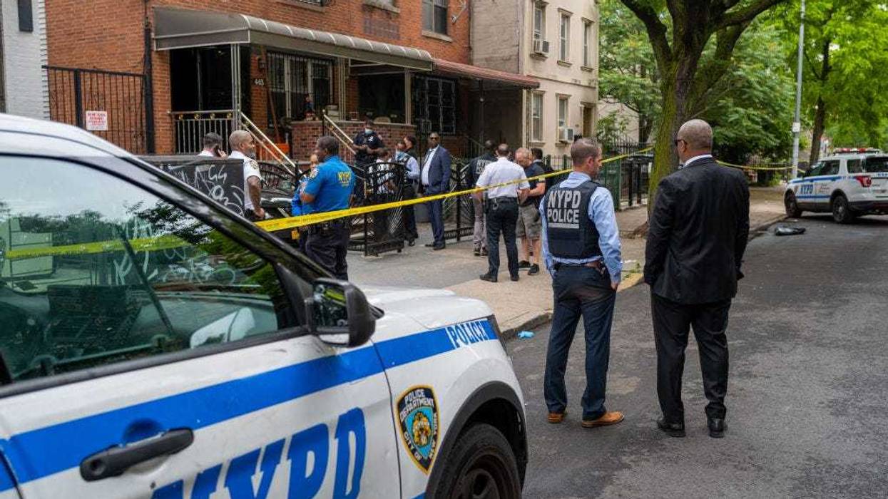Police gather at the scene of a shooting in Brooklyn that left one person dead on June 16, 2022, in New York City.
