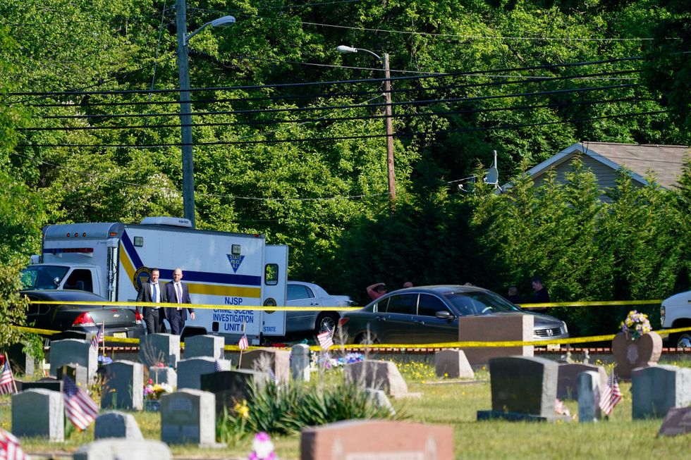 Police gather at the scene of a shooting in Fairfield Township, N.J., Sunday, May 23, 2021