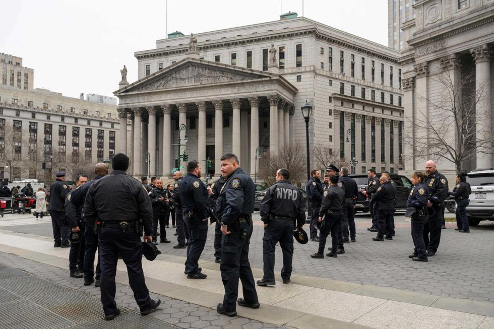 Police gather near the Manhattan Criminal Court and Manhattan District Attorney