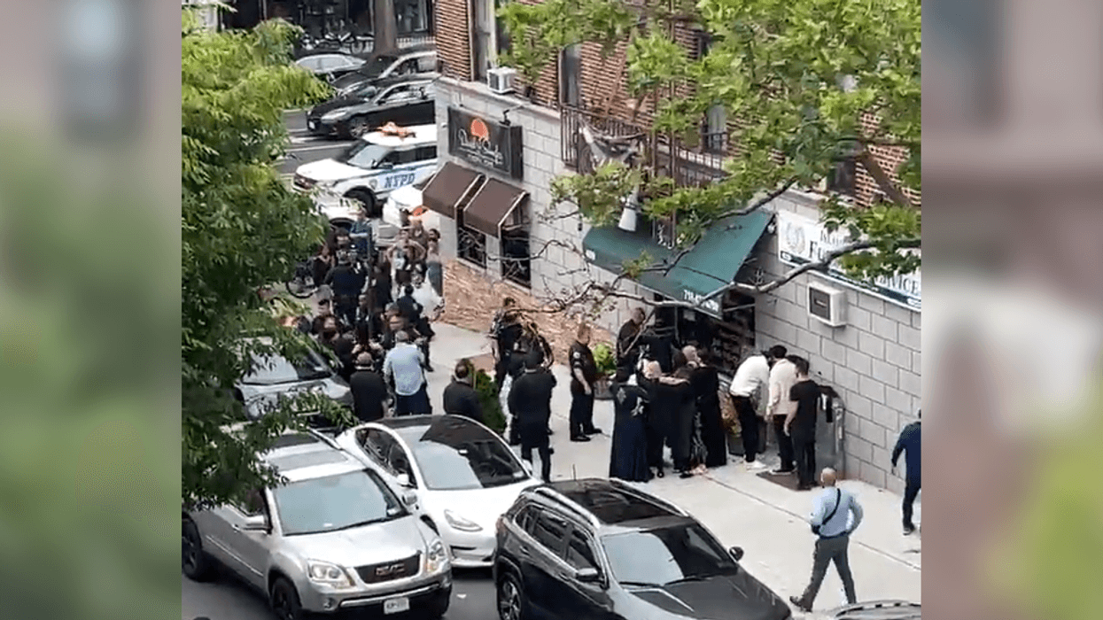 Police gathered around the area where two men were slashed on Saturday.