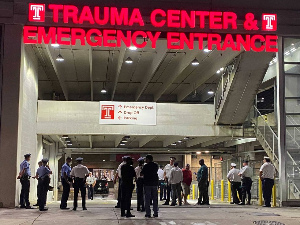Police gathering outside the Trauma Center at Temple University Hospital.