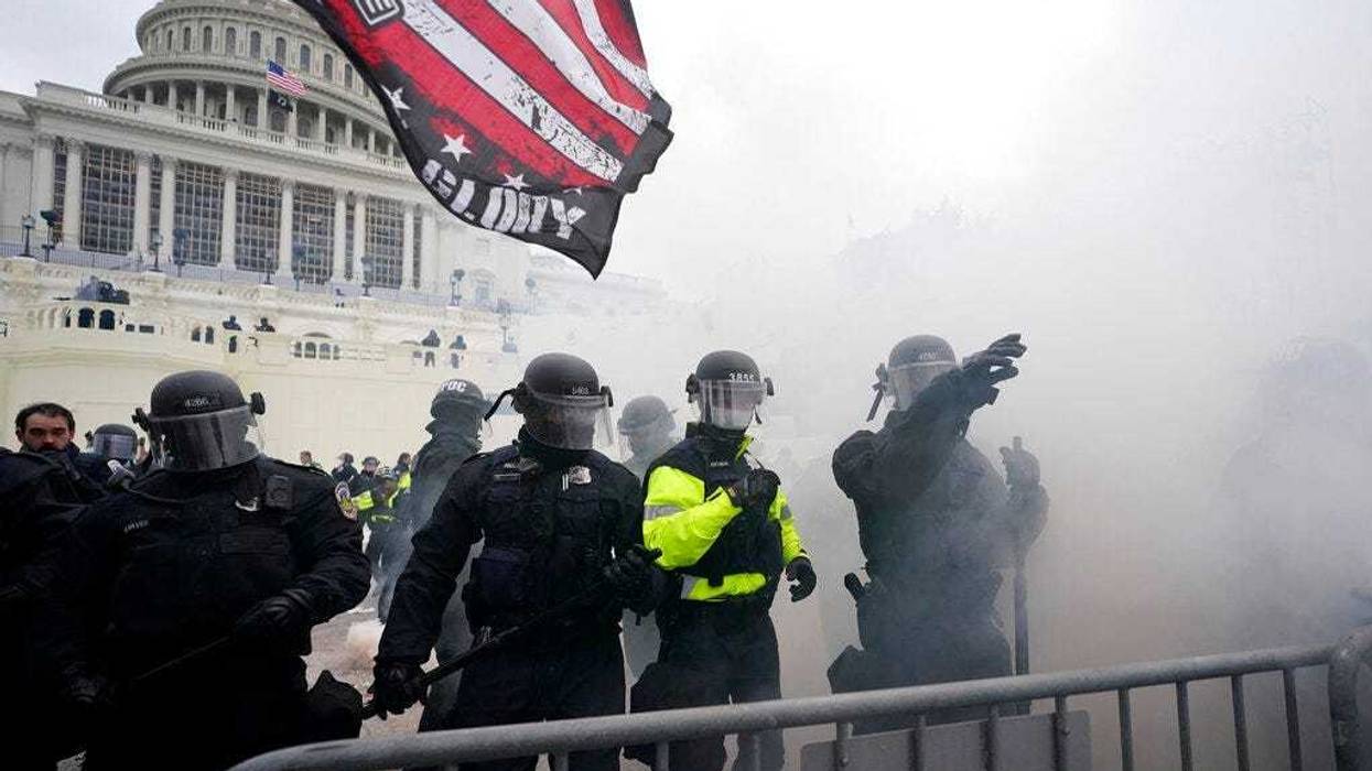 Police hold off Trump supporters who tried to break through a police barrier, Wednesday, Jan. 6, 2021, at the Capitol in Washington.