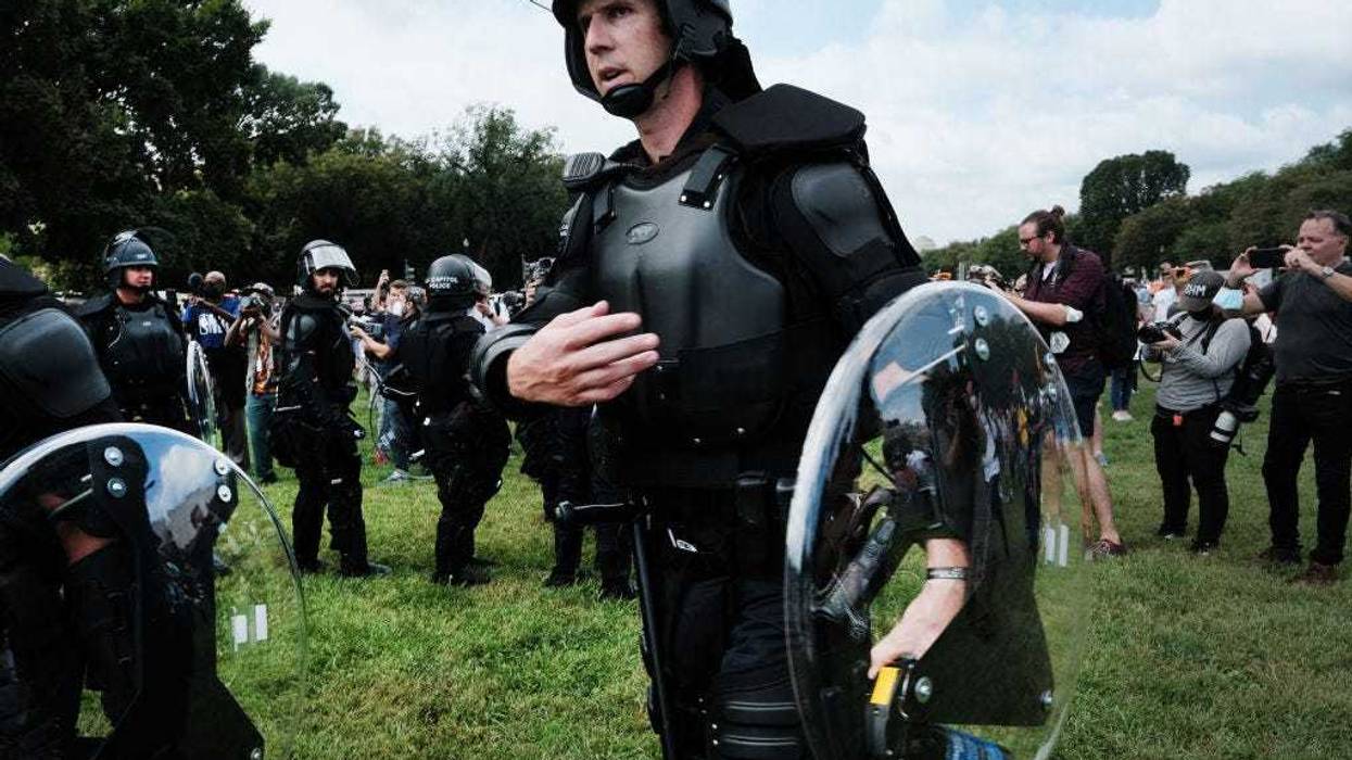 Police in riot gear stand in front of the U.S. Capitol during the 'Justice for J6’ rally in support of those charged in the January 6 attack on the U.S. Capitol on September 18, 2021 in Washington, DC. Protestors to gathered in Washington, DC on Saturday to support over 600 people arrested and charged in connection with the January 6 attempted insurrection at the U.S. Capitol. (Photo by Spencer Platt/Getty Images)