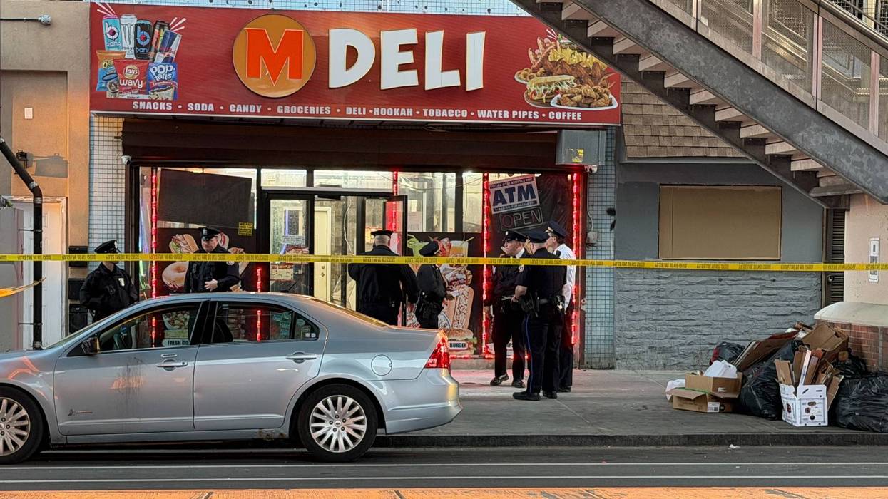 Police investigate a shooting near 60th and Market streets in West Philadelphia's Cobbs Creek section.