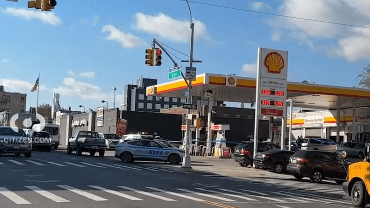 Police investigate after two men were stabbed in an attempted robbery outside a gas station in Sunset Park.