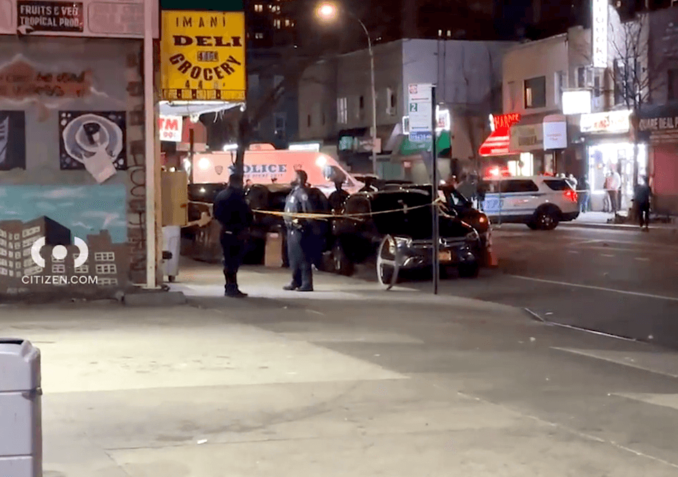 Police investigate at the scene of the double shooting in Brownsville