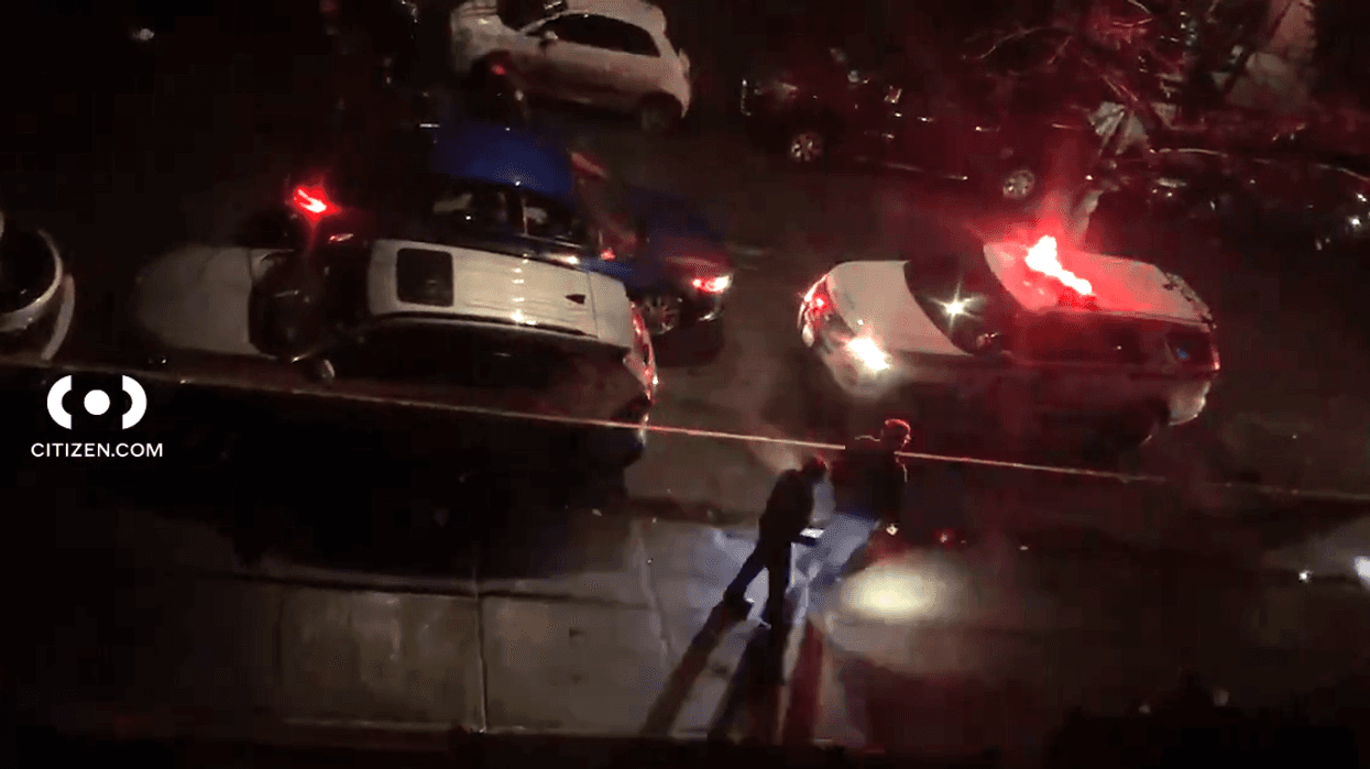Police investigate at the scene where a 28-year-old man was shot and killed in Brownsville