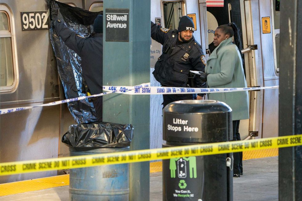 Police investigate at the train where a woman was set on fire in Coney Island on Dec. 22
