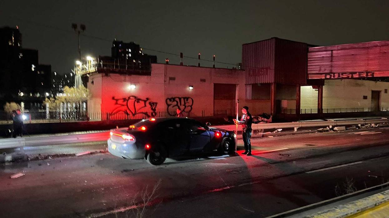 Police investigate near the remains of the Tesla on the FDR Drive at 71st Street on Feb. 4, 2025