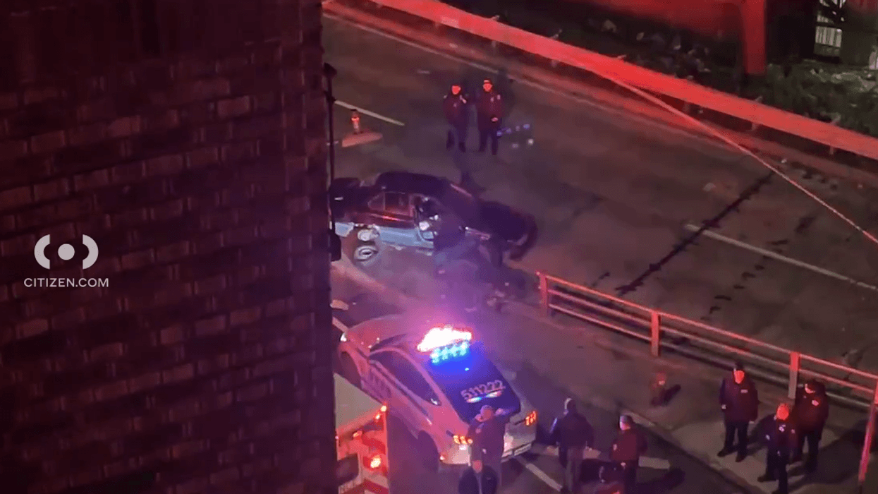 Police investigate near the suspect's disabled car, just south of the George Washington Bridge in Washington Heights