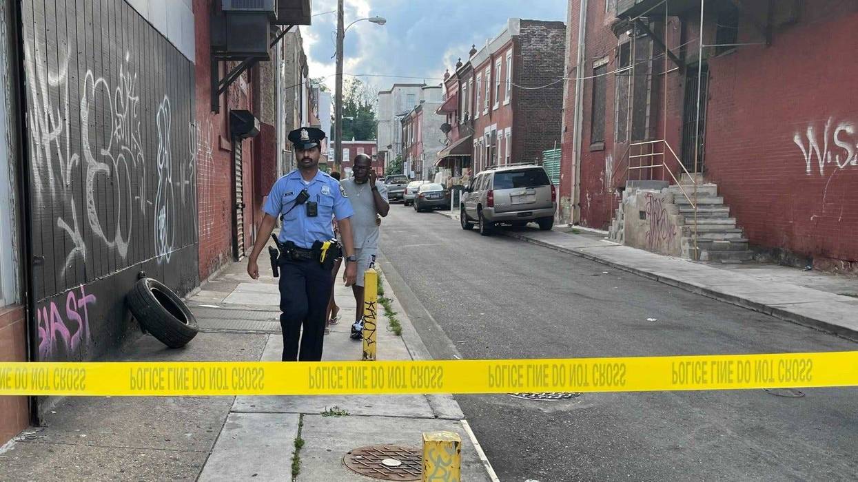Police investigate the scene near Broad Street and Erie Avenue, where they say a 10-year-old boy accidentally shot himself to death.