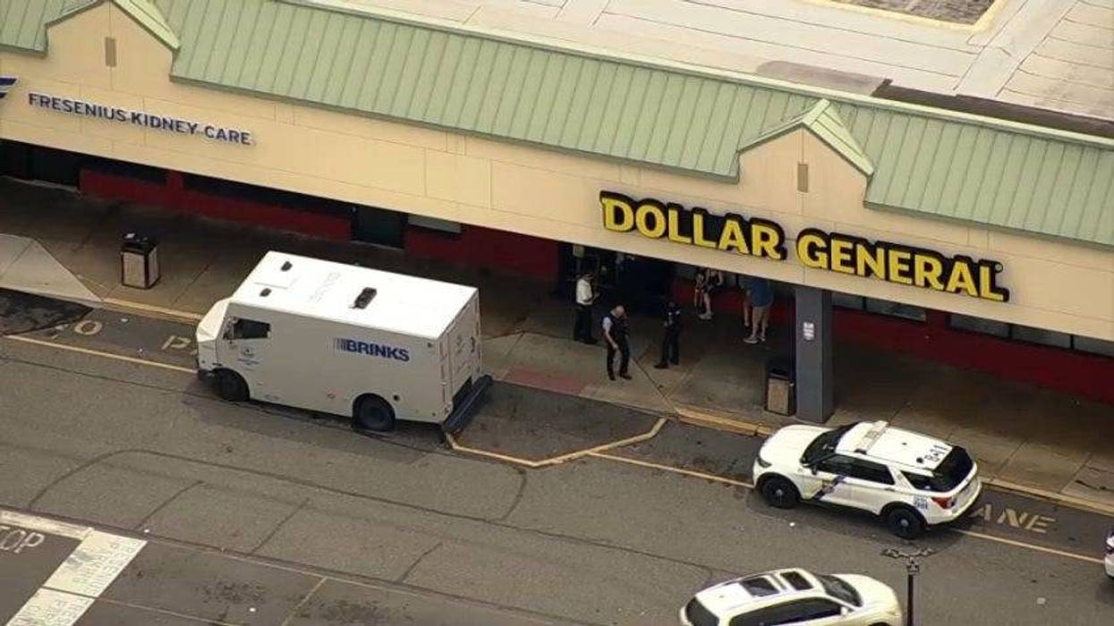 Police investigate the scene of a Brinks armored truck robbery in the city's Holmesburg section.