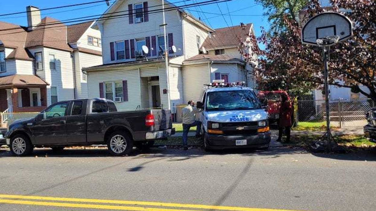 Police investigated outside the home on Heberton Avenue in Port Richmond after a woman's body was discovered in a storage bin earlier in the day