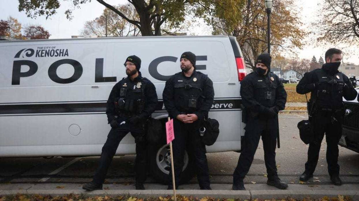 Police keep watch as demonstrators gather outside of the Kenosha County Courthouse as the jury deliberates in the trial of Kyle Rittenhouse on November 16, 2021 in Kenosha, Wisconsin.