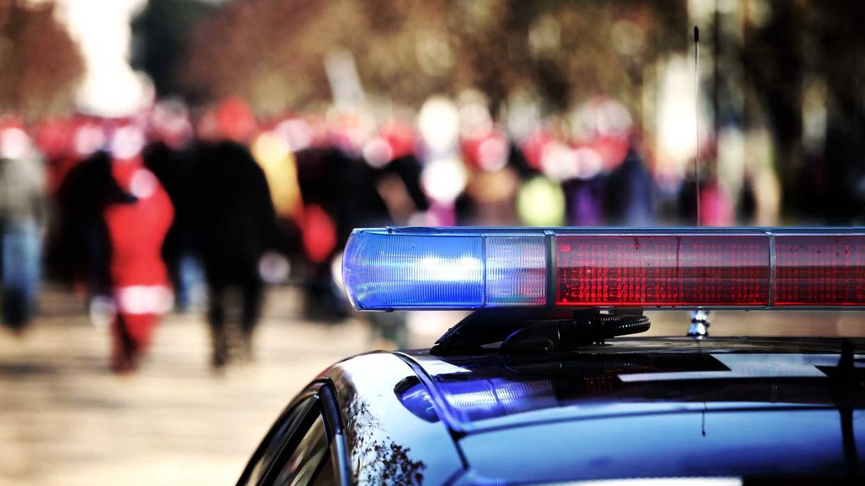 Police lights flashing while protestors gathering.