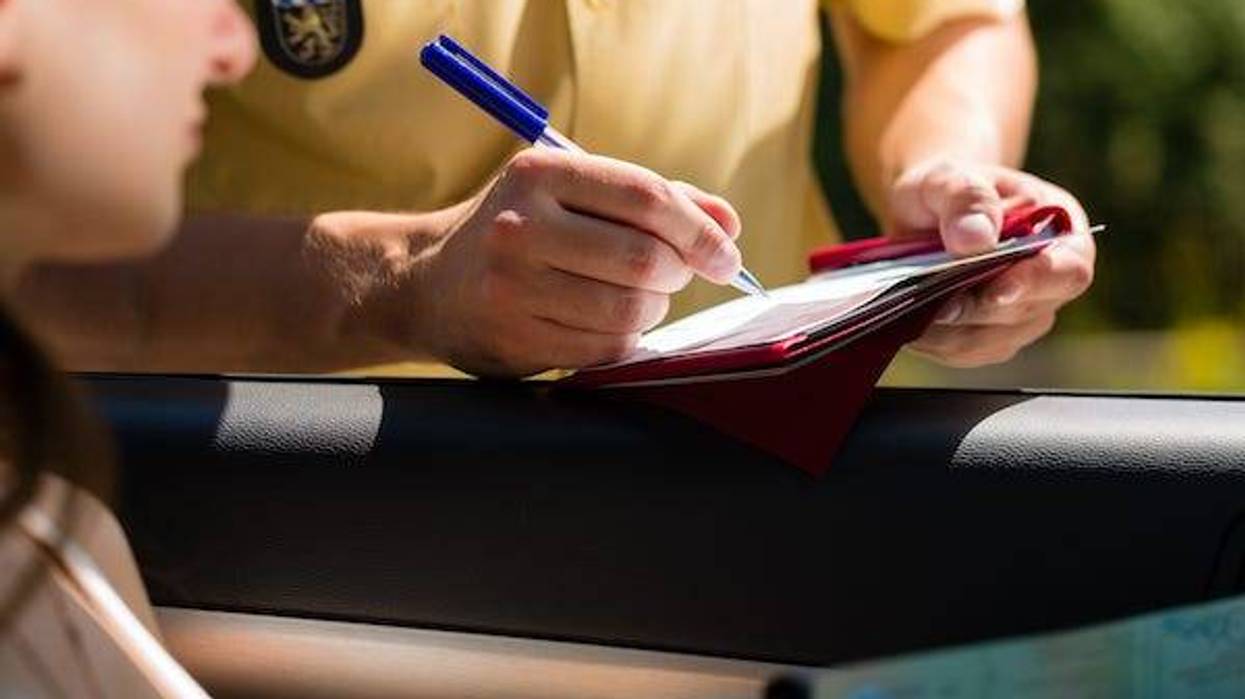 Police officer writing woman a ticket