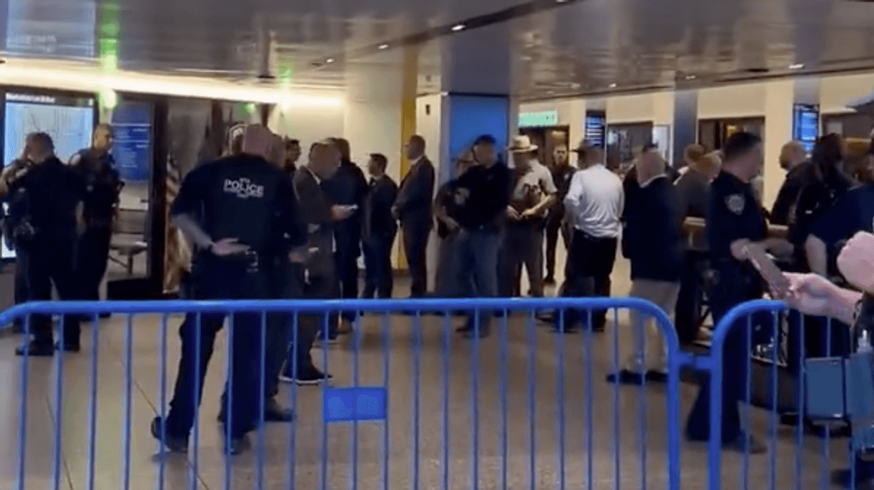 Police officers are seen at Penn Station after the shooting