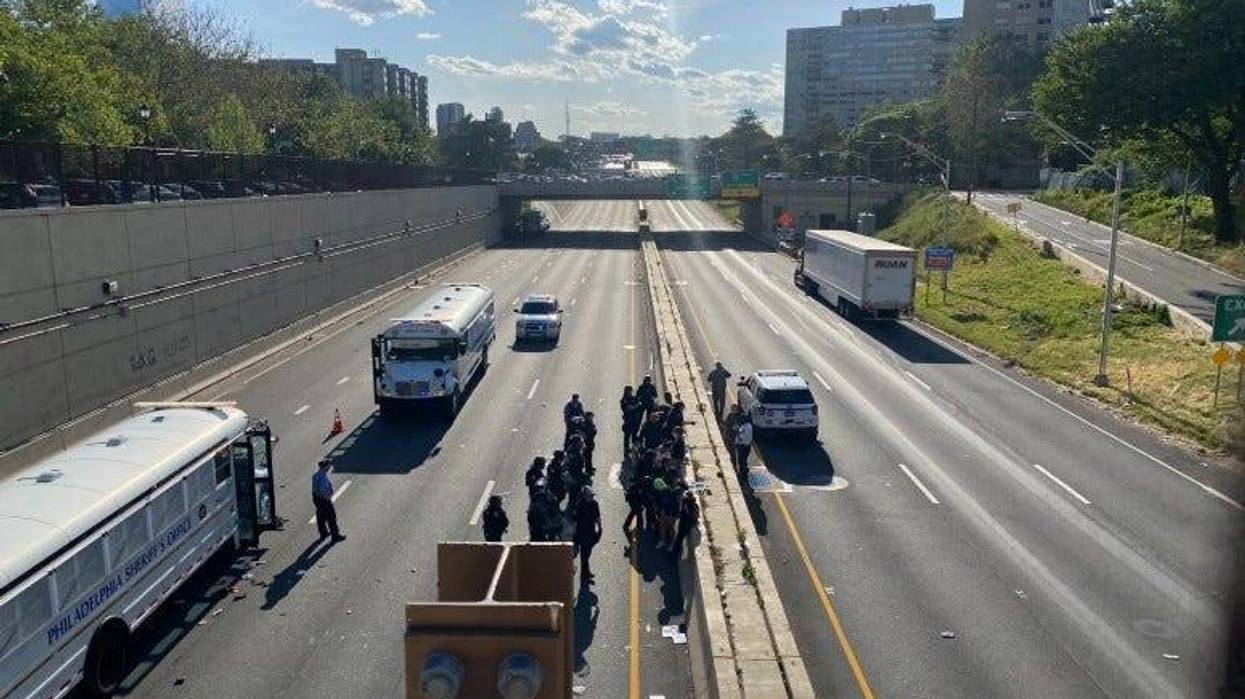 Police officers arresting protesters on the Vine Street Expressway