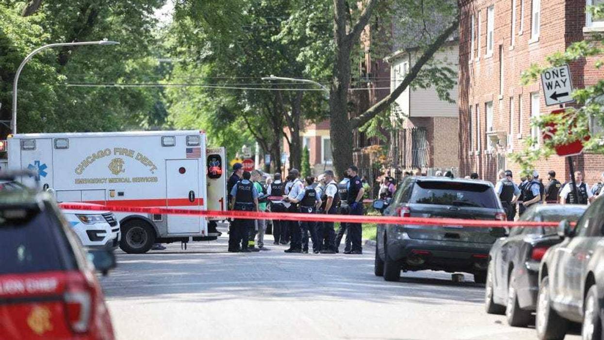 Police officers at the scene where a person was shot during a standoff with police Friday morning in the 100 block of South Kilpatrick Avenue.