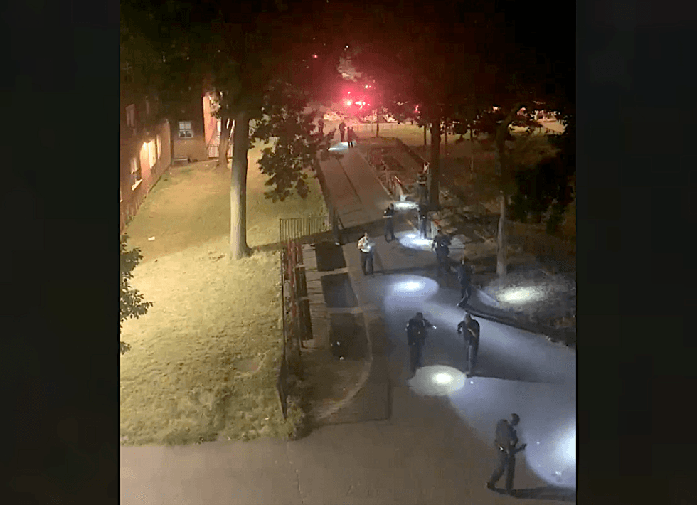 Police officers canvass a courtyard near 229th Drive North and East 229th Street at the Edenwald Houses following a shooting early Thursday