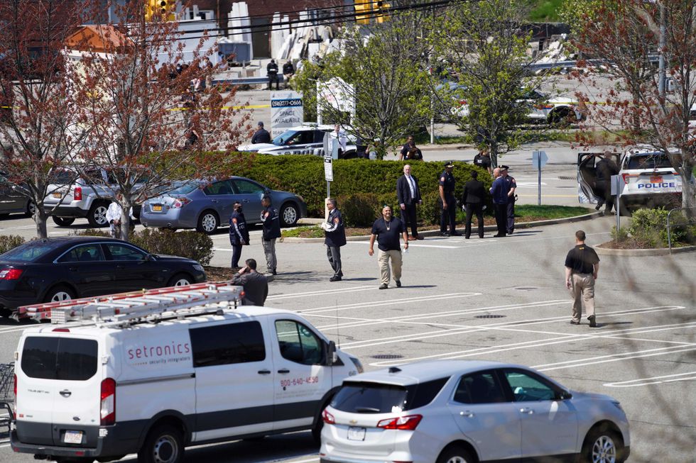 Police officers gather outside a Stop & Shop grocery store where a shooting took place in West Hempstead, New York, the United States, on April 20, 2021