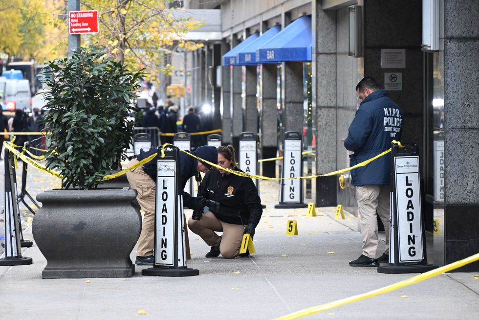 Police officers investigate the scene where United Healthcare CEO Brian Thompson was fatally shot in Midtown Manhattan on December 4, 2024.