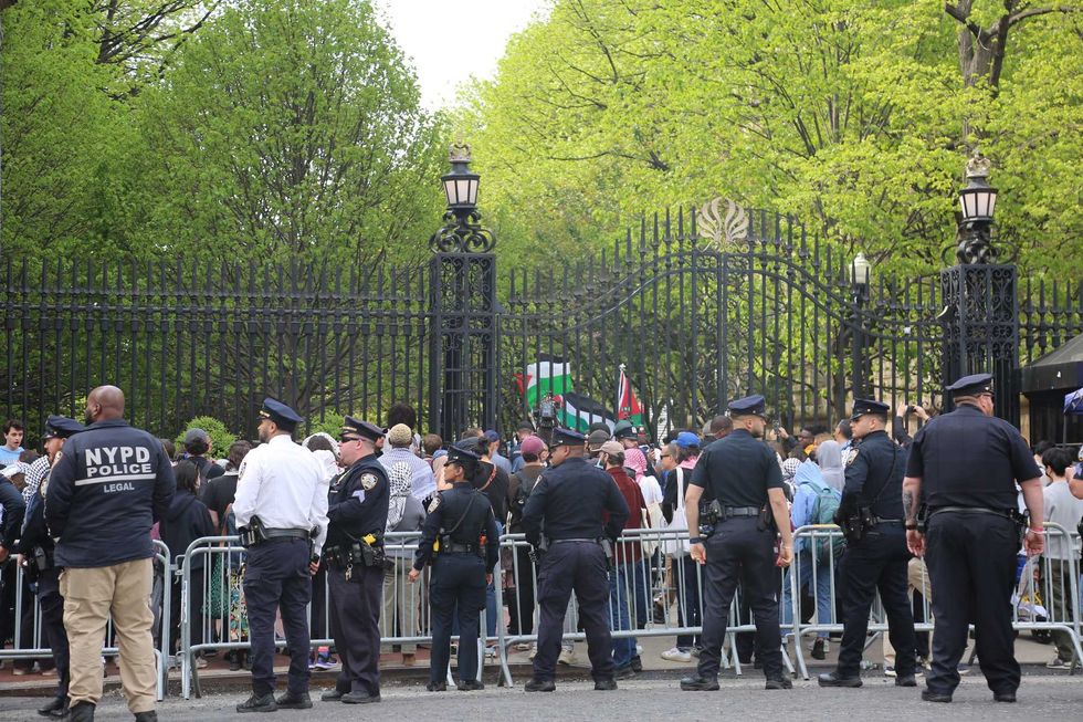 Police officers stand at Columbia University