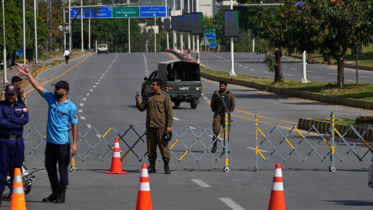 Police officers stand guard at a checkpoint ahead of the second round of negotiations between the U.S. and Iran, in Islamabad, Pakistan, Tuesday, April 21, 2026.