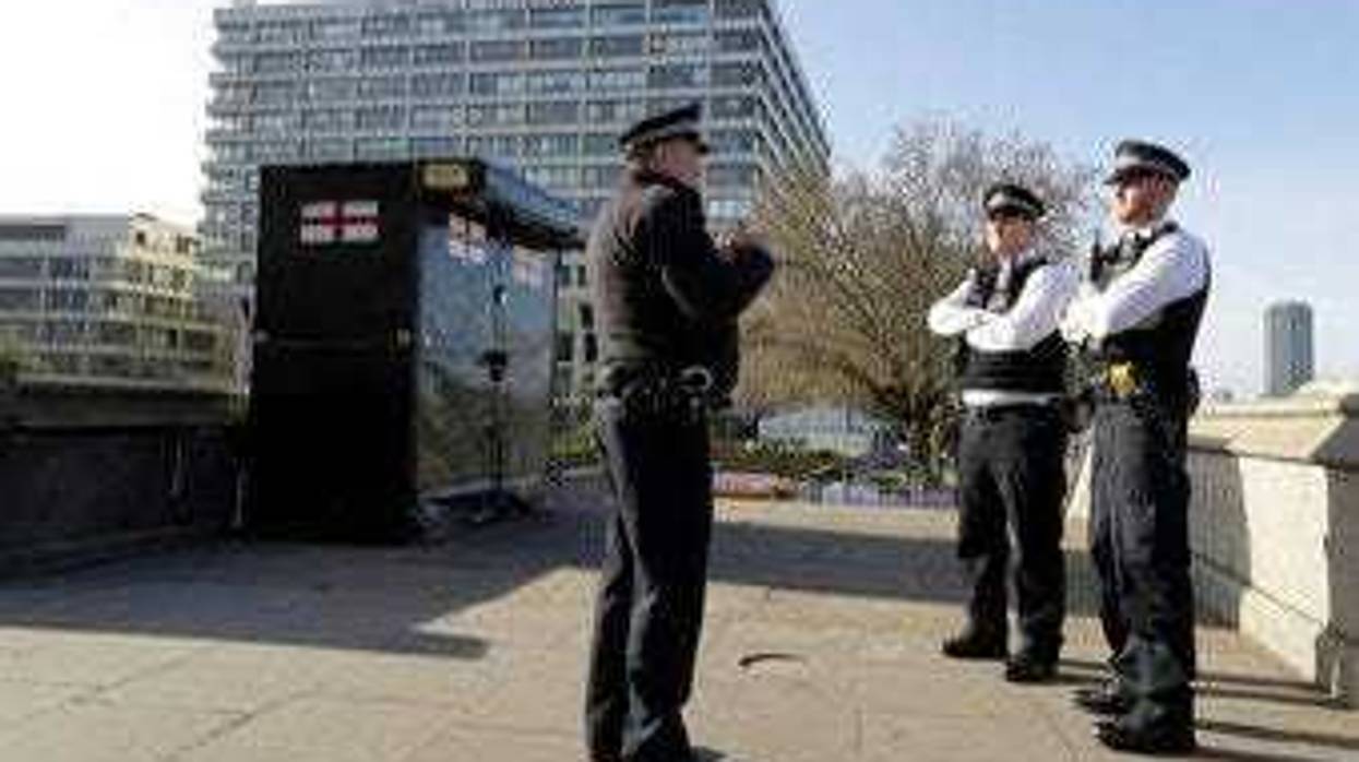 Police officers stand outside St Thomas' Hospital in central London as British Prime Minister Boris Johnson was moved to intensive care after his coronavirus symptoms worsened in London, Tuesday, April 7, 2020. (AP Photo/Kirsty Wigglesworth)