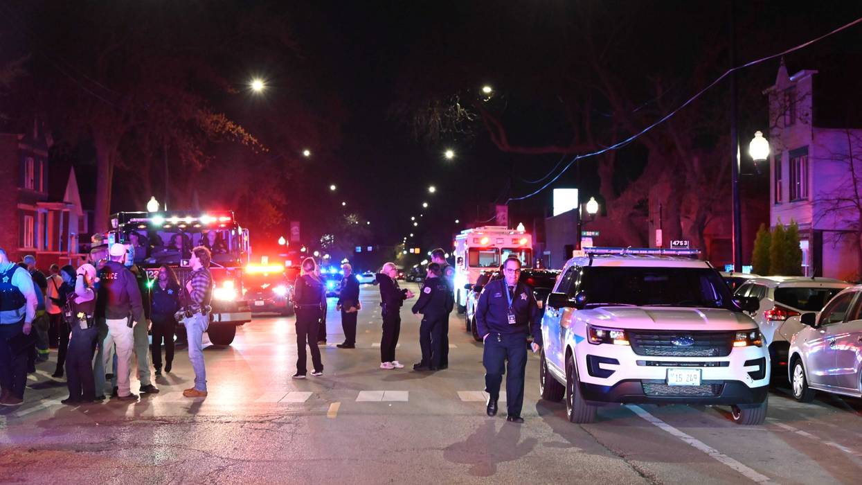 Police officers take security measures after 11 people, including seven adults and four children, were shot in Chicago's Back of the Yards neighborhood on April 13, 2024. An 8-year-old girl died after the shooting.