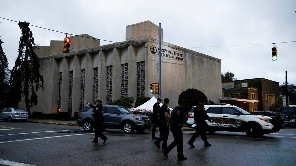 Police officers walk outside the Tree of Life Synagogue