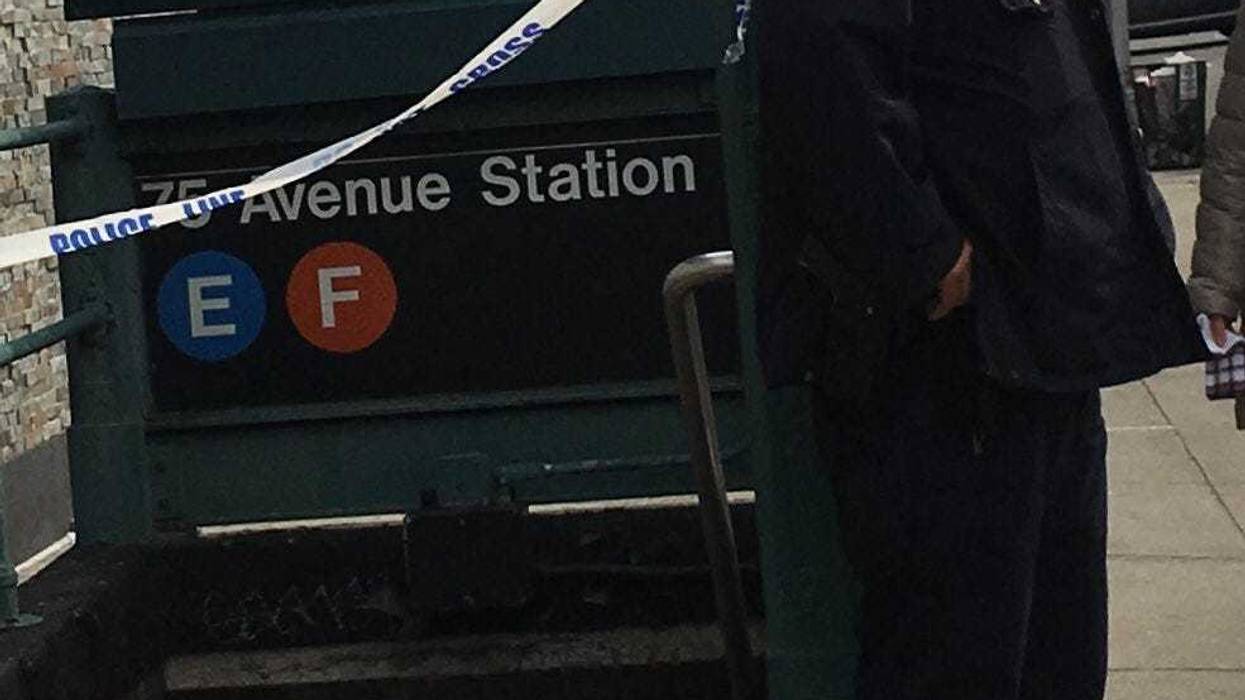 Police on the scene in Queens where a gunshot victim dragged himself off an F train.