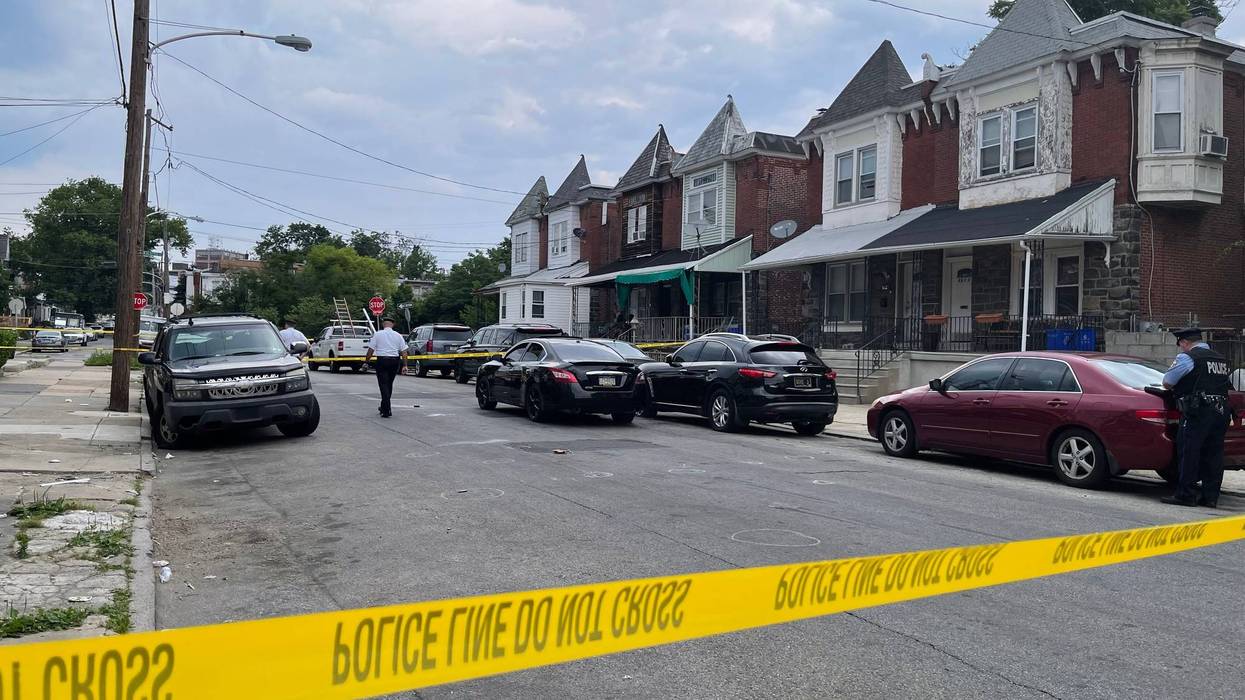 Police on the scene of a triple shooting in the city's Overbrook section. Two men were killed, and a three-year-old boy wounded.