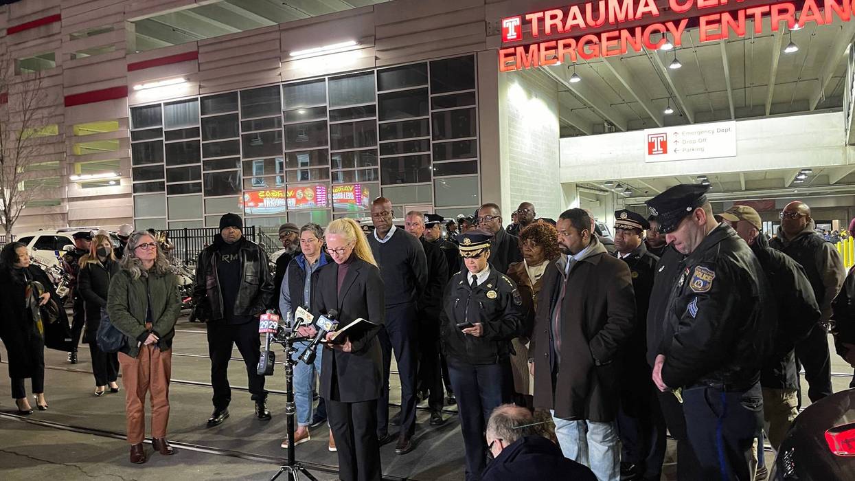 Police personnel, others gather outside Temple University Hospital, where a Temple University police officer died after being shot Saturday night near North 18th Street and West Montgomery Avenue.