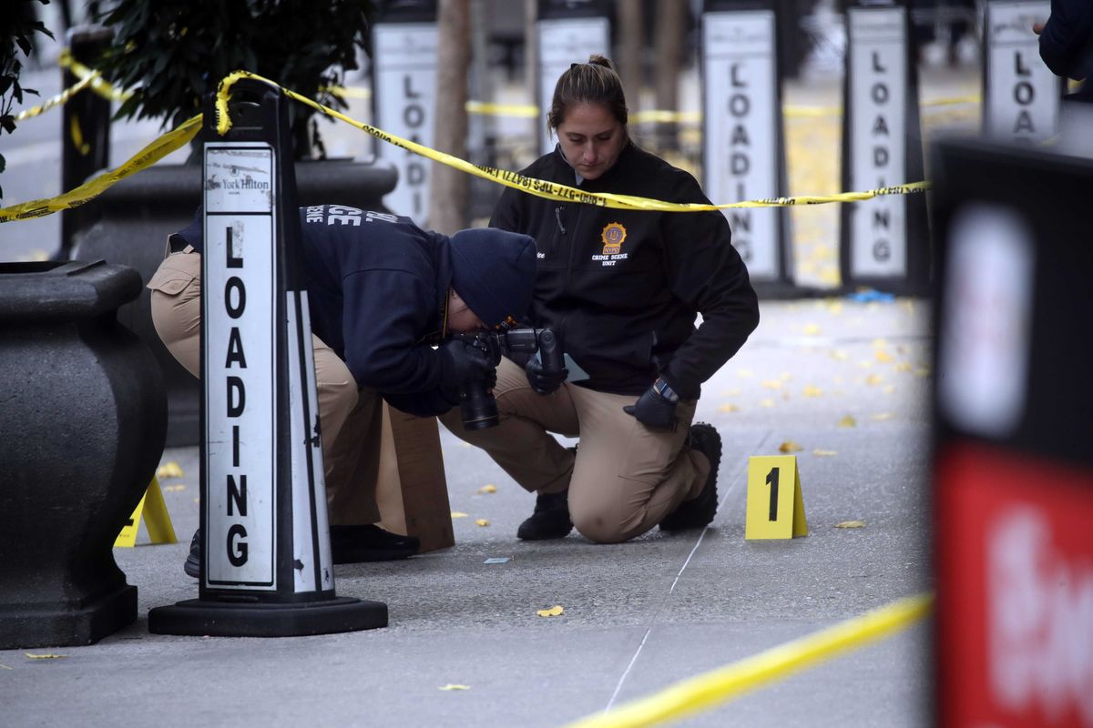 Police place bullet casing markers outside of a Hilton Hotel in Midtown Manhattan where United Healthcare CEO Brian Thompson was fatally shot on December 4, 2024