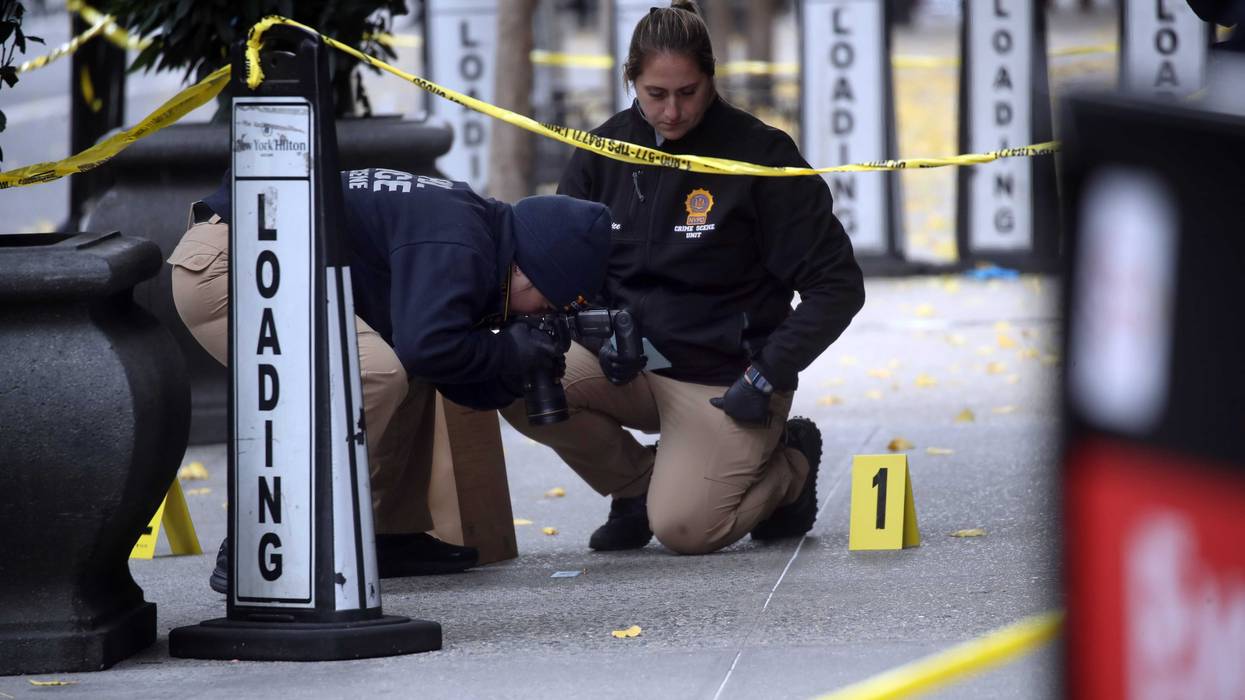 Police place bullet casing markers outside of a Hilton Hotel in Midtown Manhattan where United Healthcare CEO Brian Thompson was fatally shot on December 4, 2024
